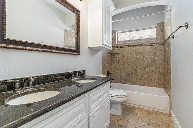 full bathroom featuring vanity, tile patterned floors, toilet, and tiled shower / bath