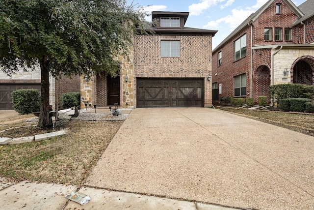 view of front of home featuring an attached garage, stone siding, concrete driveway, and brick siding