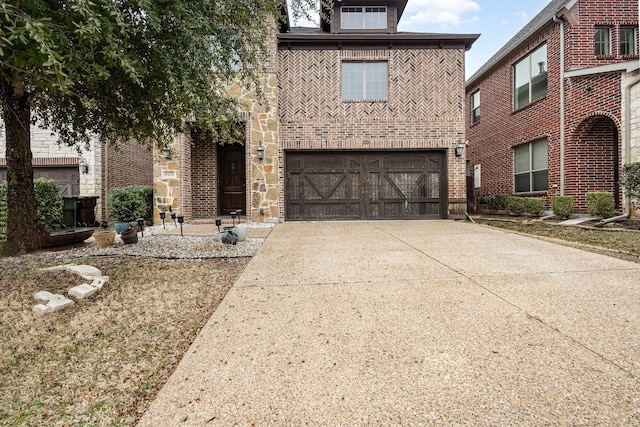 view of front of property featuring stone siding, concrete driveway, brick siding, and an attached garage