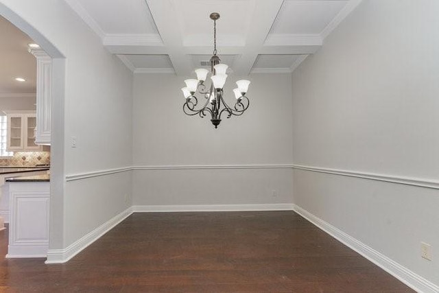 unfurnished dining area featuring beamed ceiling, coffered ceiling, dark hardwood / wood-style flooring, and crown molding