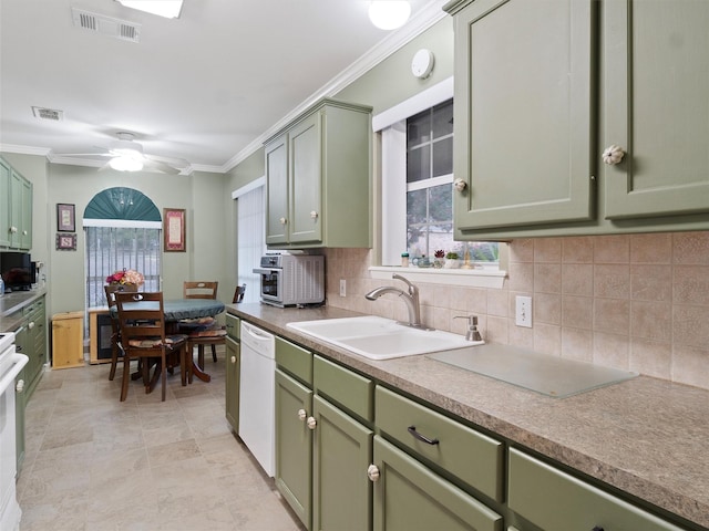 kitchen featuring sink, crown molding, white appliances, ceiling fan, and green cabinetry