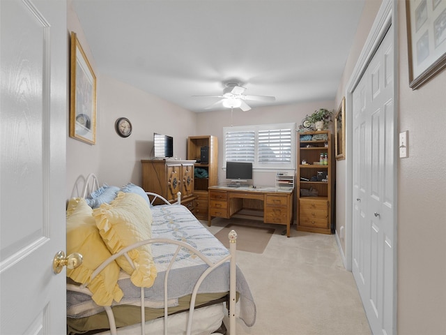 carpeted bedroom featuring ceiling fan and a closet