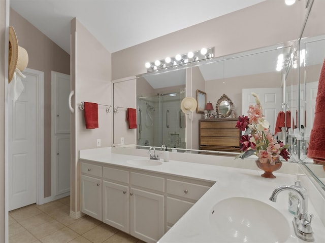 bathroom featuring lofted ceiling, vanity, an enclosed shower, and tile patterned flooring