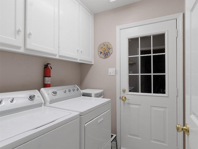 washroom featuring cabinets and washer and dryer