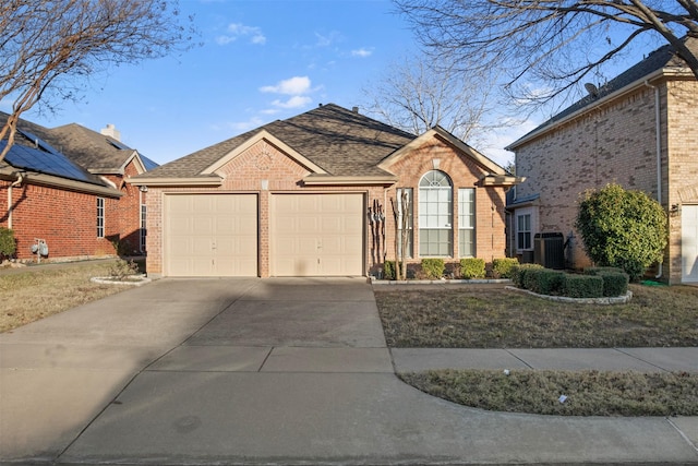 view of front of property featuring a garage and central air condition unit