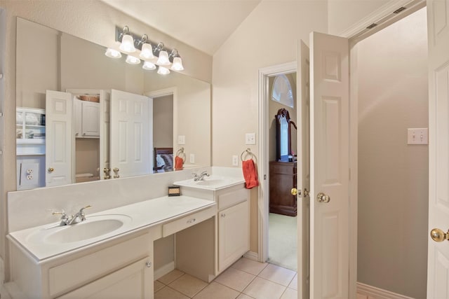 bathroom featuring tile patterned floors, lofted ceiling, and vanity