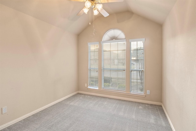 spare room featuring lofted ceiling, ceiling fan, and carpet flooring