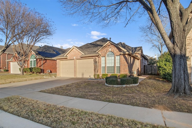 view of front of property featuring a garage and a front yard