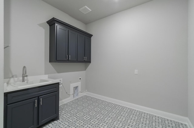 clothes washing area featuring cabinets, electric dryer hookup, and sink