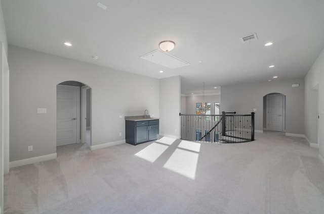 unfurnished room featuring sink and light colored carpet