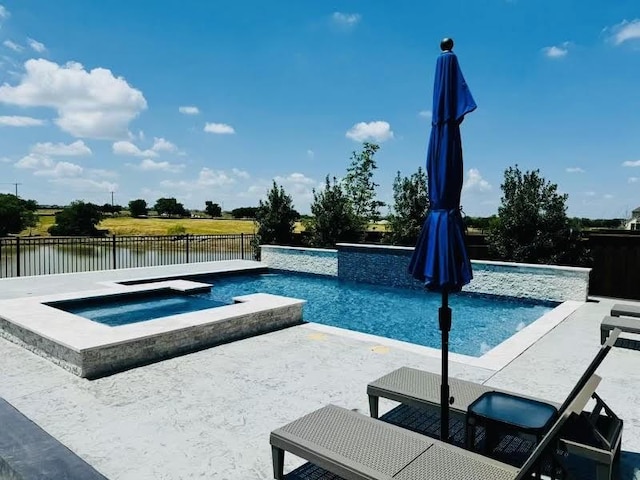 view of swimming pool featuring a patio, a water view, and an in ground hot tub