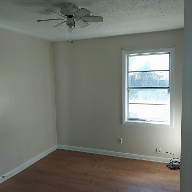 unfurnished room featuring hardwood / wood-style floors, a textured ceiling, and ceiling fan