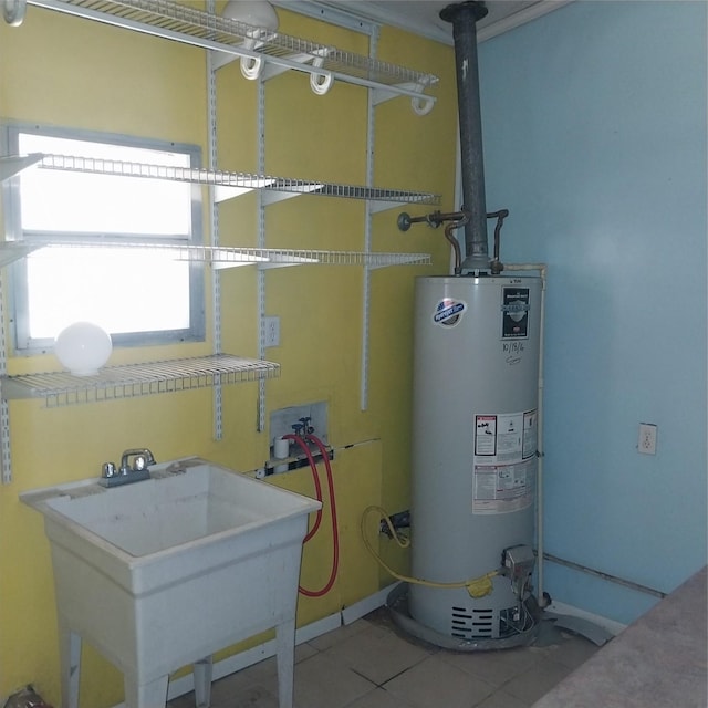 utility room with sink and water heater