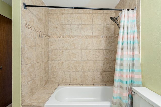 bathroom featuring toilet and shower / tub combo with curtain