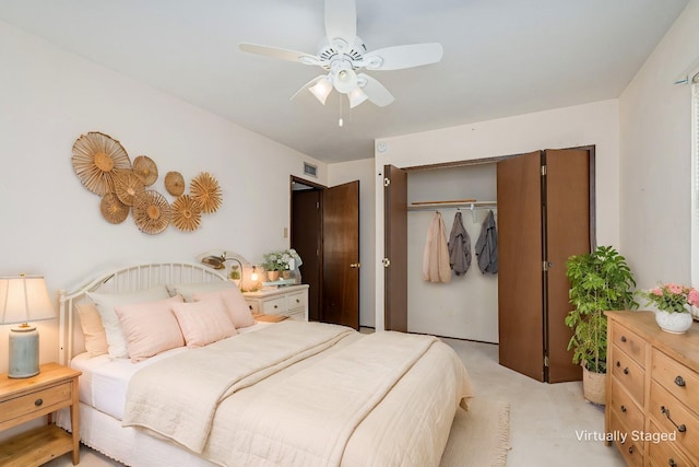bedroom featuring a closet, a ceiling fan, light colored carpet, and visible vents