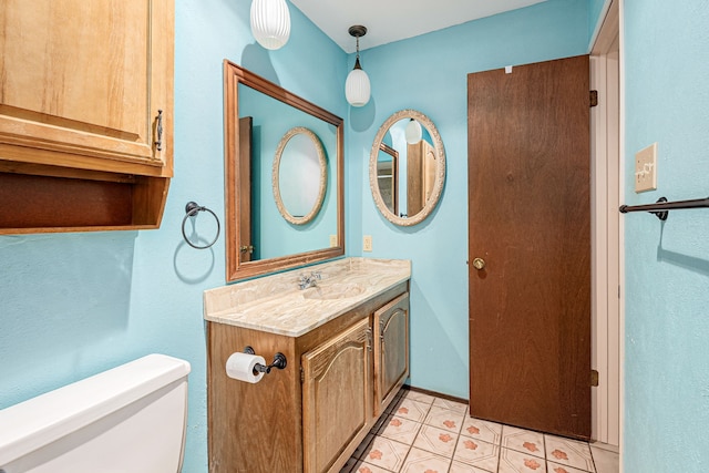 bathroom with vanity, tile patterned floors, and toilet