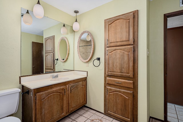 bathroom featuring tile patterned floors, toilet, and vanity