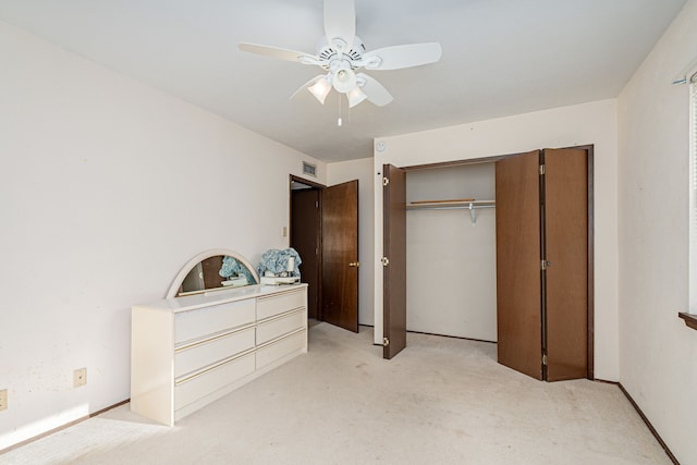 carpeted bedroom with ceiling fan and a closet