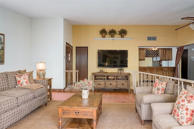 living room featuring ceiling fan and light hardwood / wood-style floors