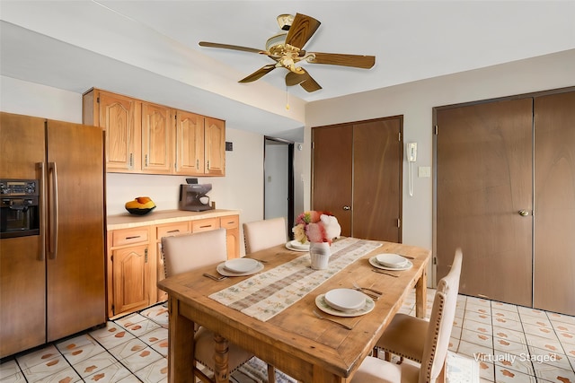 dining room with light tile patterned floors and a ceiling fan