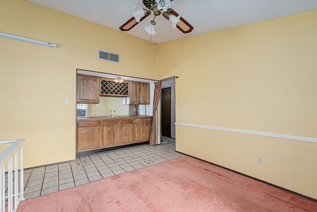 kitchen with light tile patterned flooring, ceiling fan, and sink