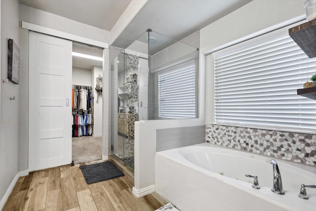 bathroom with plus walk in shower and hardwood / wood-style floors