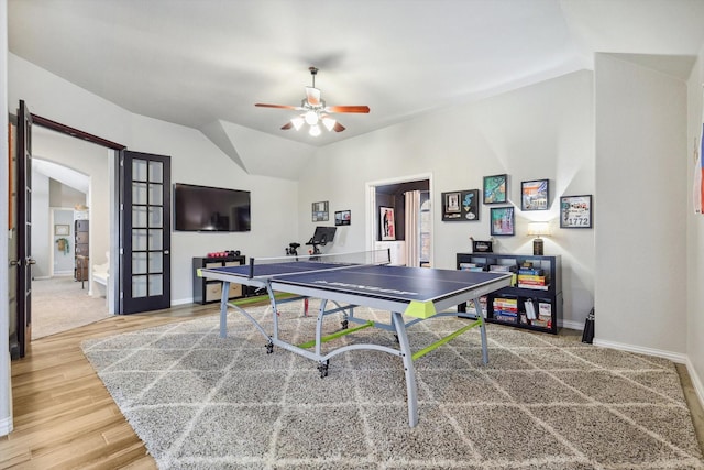 game room with vaulted ceiling, hardwood / wood-style floors, ceiling fan, and french doors