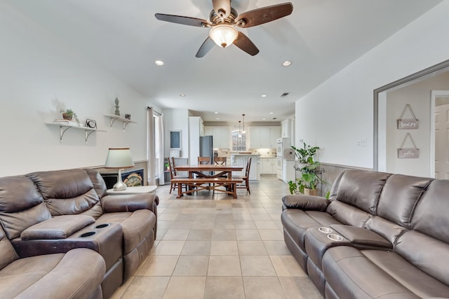 living room featuring ceiling fan and light tile patterned floors