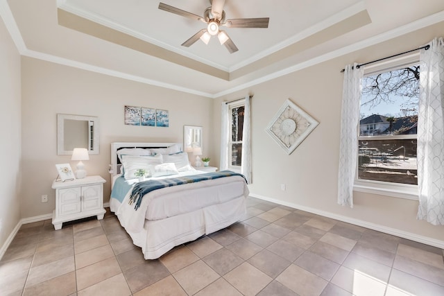 bedroom with crown molding, a tray ceiling, tile patterned floors, and ceiling fan