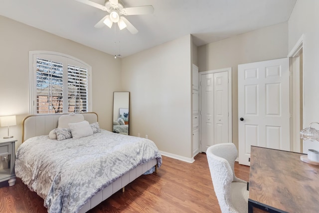 bedroom with ceiling fan, wood-type flooring, and a closet