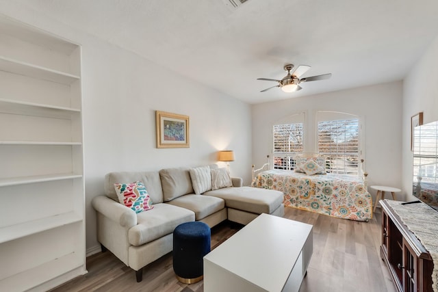 living room featuring ceiling fan and wood-type flooring