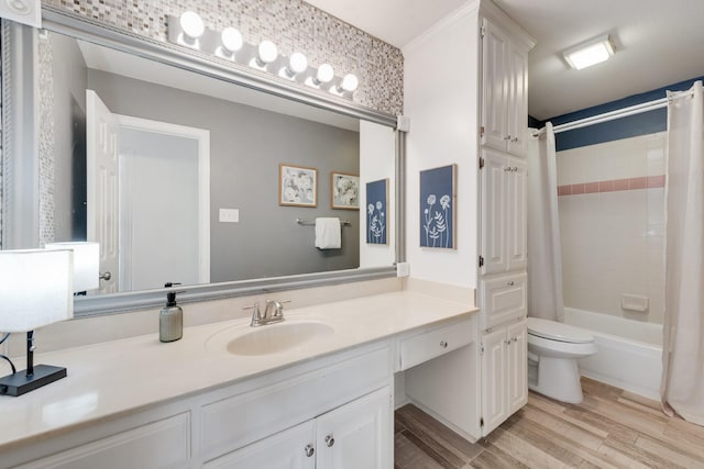 full bathroom with hardwood / wood-style flooring, vanity, shower / tub combo with curtain, and toilet