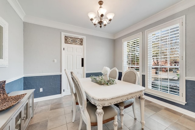 dining area featuring a notable chandelier, crown molding, and light tile patterned flooring