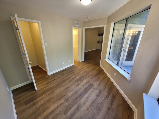 spare room with dark wood-type flooring