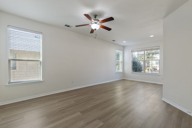 spare room with hardwood / wood-style floors and ceiling fan