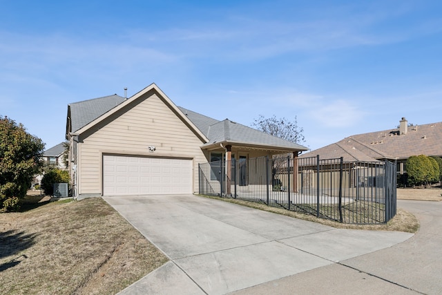 view of front of house with a garage and central air condition unit