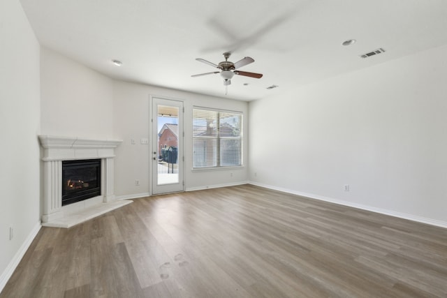 unfurnished living room featuring hardwood / wood-style flooring and ceiling fan