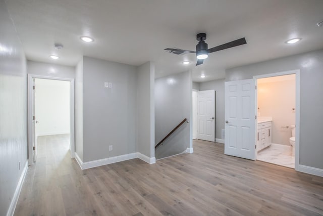 interior space featuring recessed lighting, light wood-style flooring, a ceiling fan, and baseboards