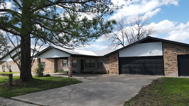 ranch-style house with a garage and a front lawn