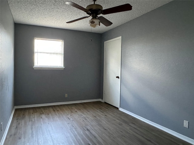 empty room featuring a textured ceiling, wood-type flooring, and ceiling fan