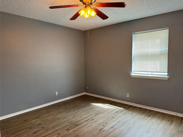 unfurnished room featuring ceiling fan, wood-type flooring, and a textured ceiling