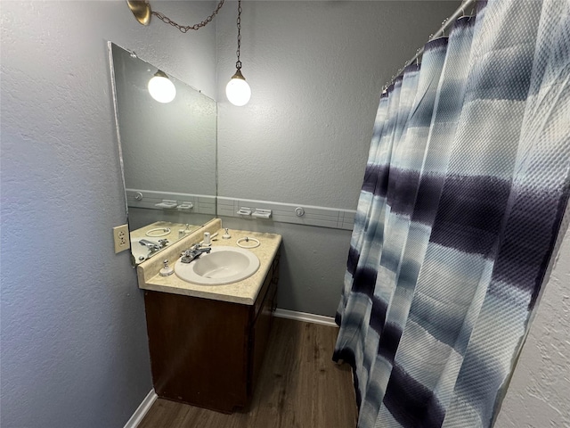 bathroom with hardwood / wood-style flooring and vanity