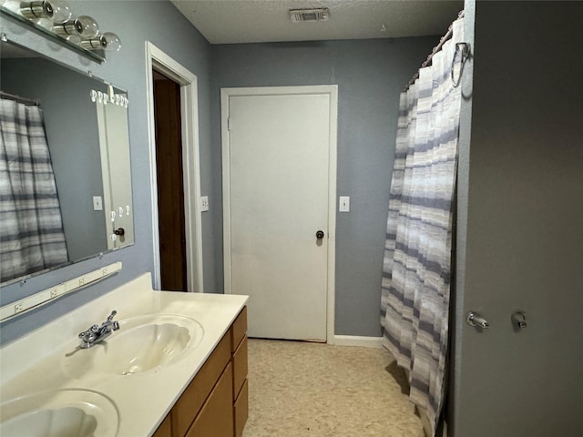 bathroom featuring vanity and a textured ceiling