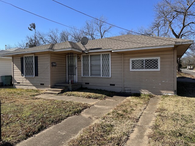 view of side of home with a lawn