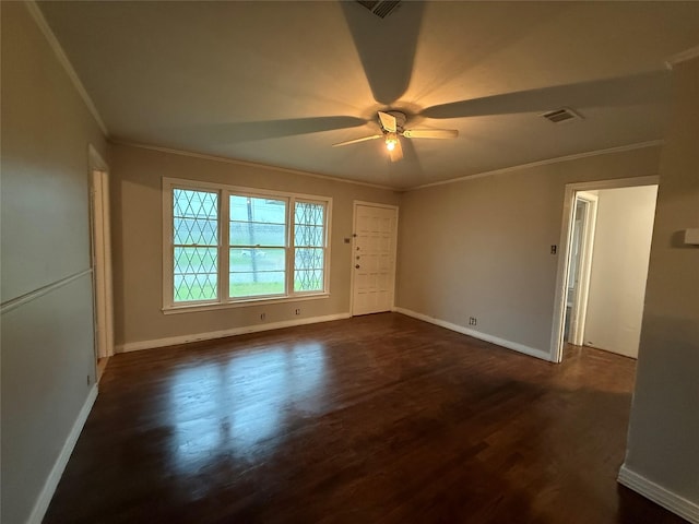 empty room featuring crown molding, a ceiling fan, dark wood-style floors, and baseboards