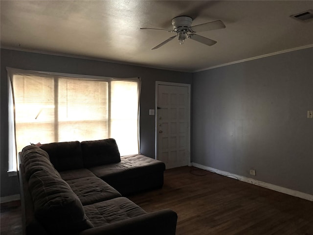 living room with ceiling fan, ornamental molding, and dark hardwood / wood-style flooring