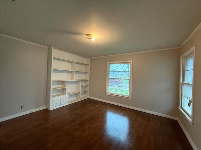 unfurnished room featuring plenty of natural light, dark wood-type flooring, baseboards, and ornamental molding