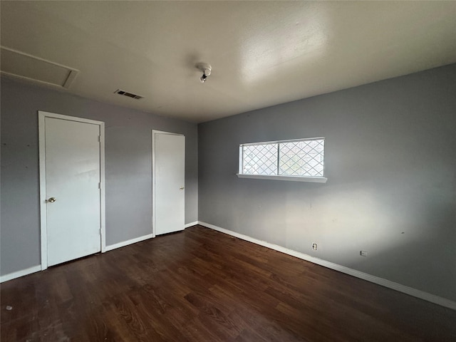 unfurnished bedroom with dark wood-type flooring