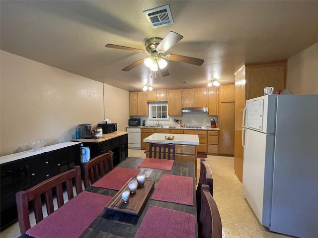 dining room featuring sink and ceiling fan