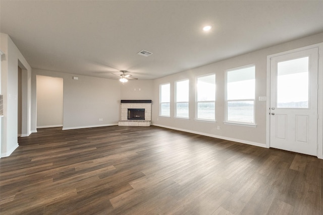 unfurnished living room with ceiling fan, dark hardwood / wood-style flooring, and a fireplace